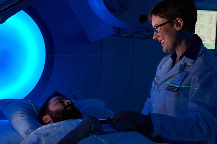 Physician with patient in scanner