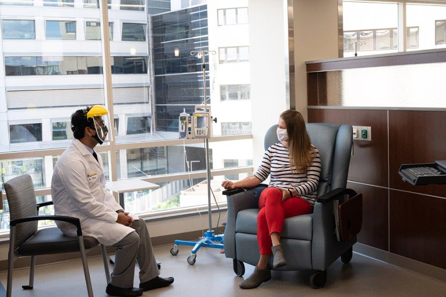 Patient discusses her treatment with her doctor in the new infusion suite at Holden Comprehensive Cancer Center