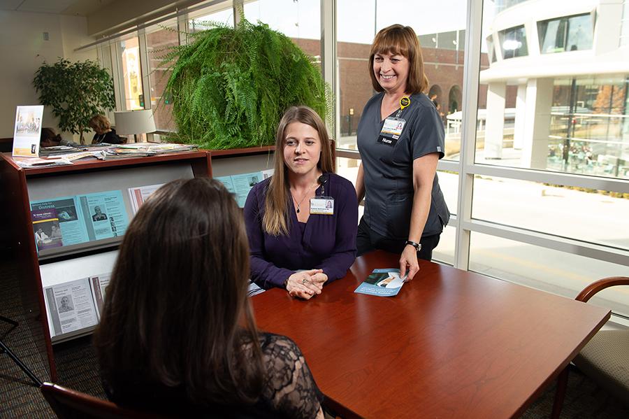 Autumn Bahlmann, BA, CTTS, talks with a tobacco treatment patient Care team members talk with a patient about their tobacco treatment plan